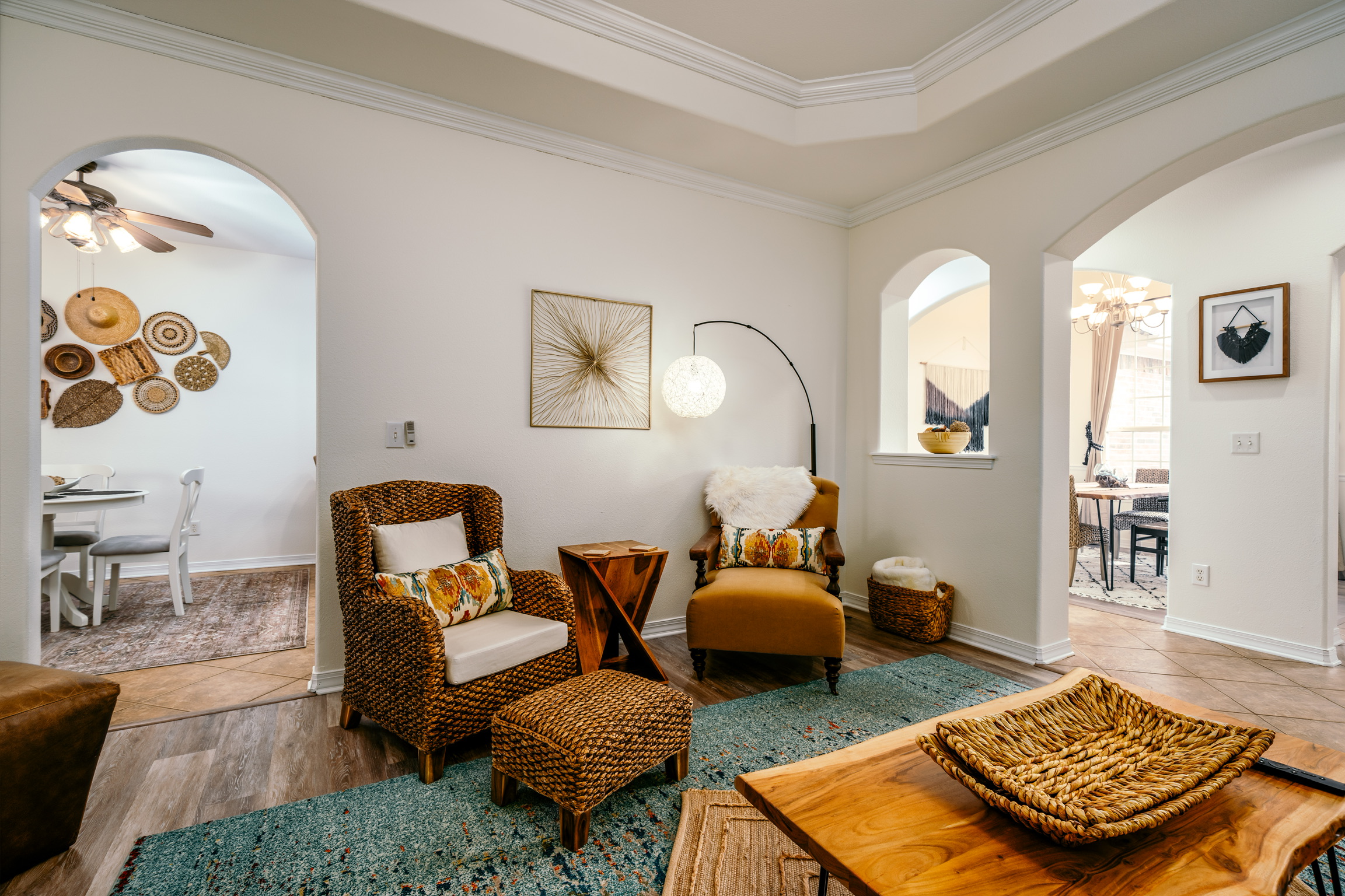 Wicker chairs and bohemian living room at Trailside Nest in Bentonville
