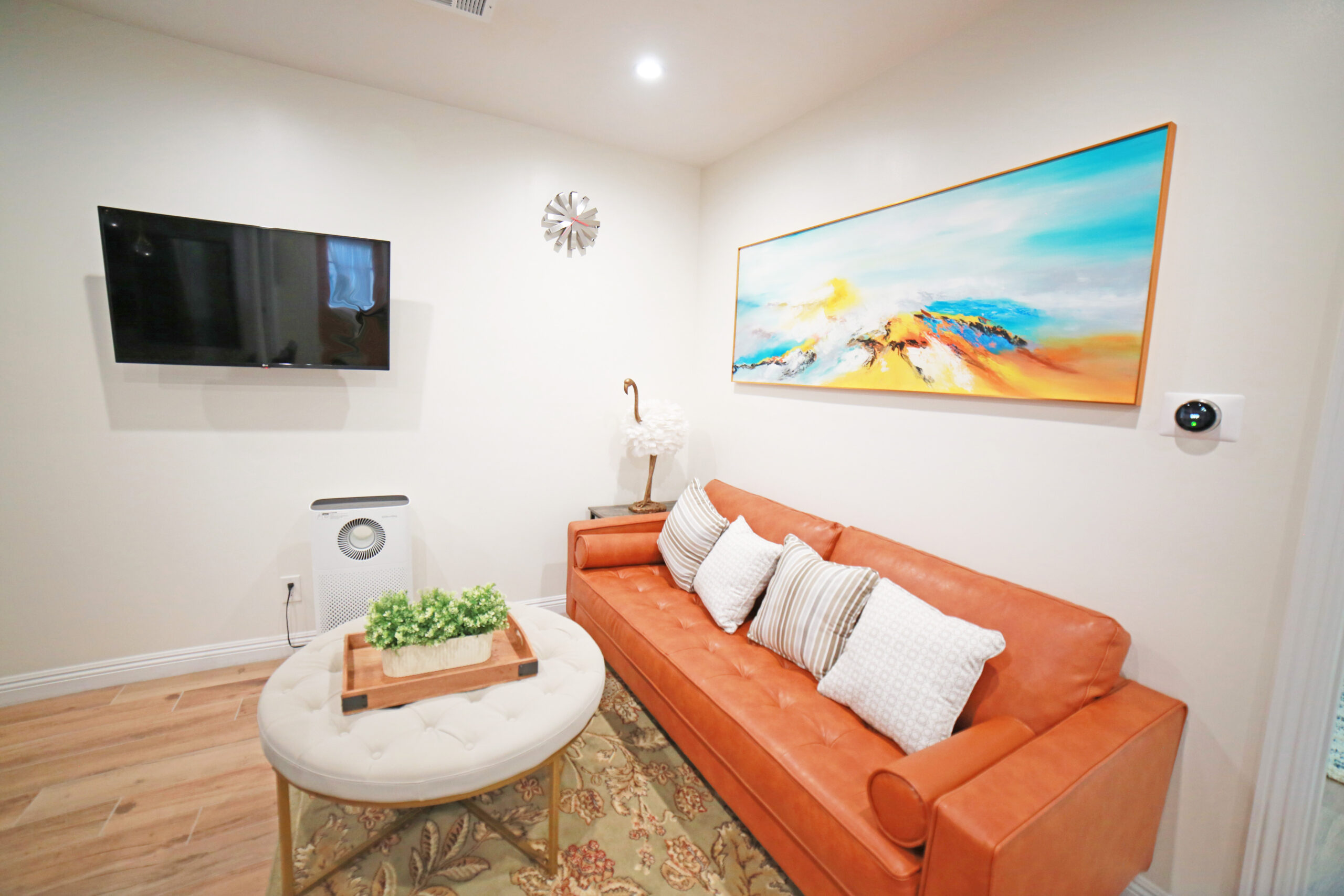 Orange sofa and bright living room at Foothills Guesthouse in Pasadena